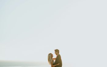 Wallpaper Woman and Man on Brown Rock Formation