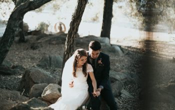 Wallpaper Groom and Bride Sitting on Rock Holding Hands