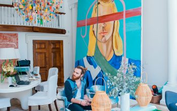 Wallpaper Man Sitting on Chair Near Woman Portrait Painting