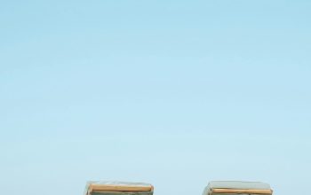 Wallpaper Two Brown Wooden Outdoor Chaise Loungers on Beach
