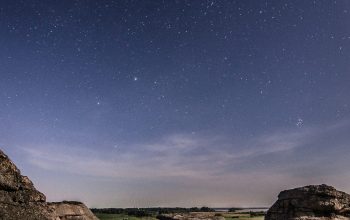 Wallpaper Rock Formations Below a Starry Sky