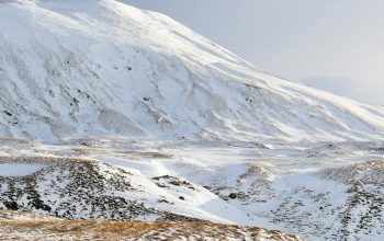 Wallpaper Snow-Capped Mountain Under Cloudy Sky