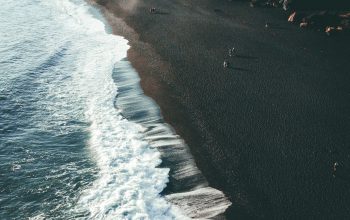 Wallpaper A Black Beach with Waves