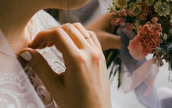 Wallpaper Selective Focus Photography of Woman in Wedding Dress Holding Flower