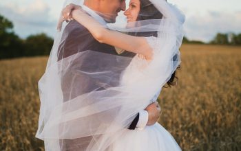 Wallpaper Smiling Newlywed Couple About to Kiss in Green Field