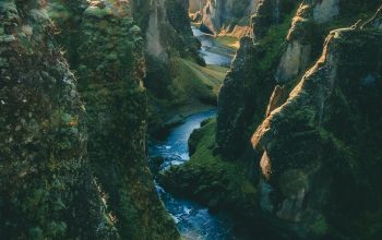 Wallpaper Green Cliffs Near Body of Water