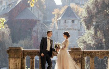 Wallpaper Woman in White Wedding Dress Stands in Front of Man in Tuxedo