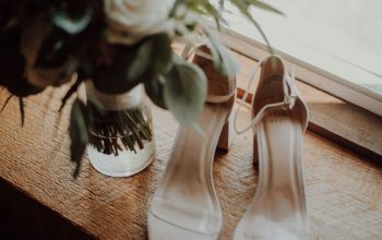 Wallpaper White Open-Toe Ankle-Strap Heels Beside Flower Vase