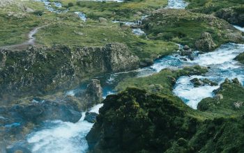 Wallpaper Mountain Ranges Surrounding a Body of Water