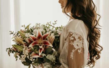 Wallpaper Woman in White Dress Holding Bouquet of Flowers