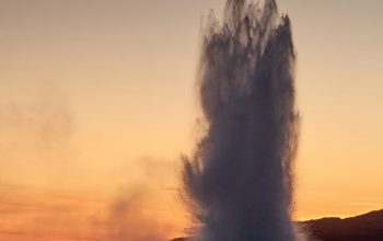 Wallpaper Silhouette of People Beside Geyser at Sunset