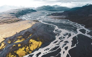 Wallpaper Aerial View of Black and White Mountains Under Cloudy Sky