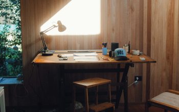 Wallpaper Brown Wooden Table with Black Laptop