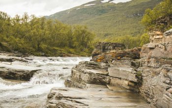 Wallpaper Brown Rock Formation on River During Daytime