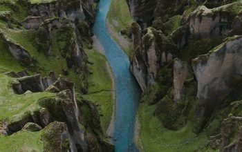 Wallpaper River in the Middle of Green Grass Covered Hill