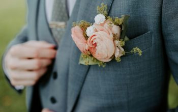 Wallpaper Man in Black Suit Holding Bouquet of Flowers