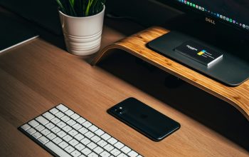 Wallpaper Black iPhone 5 Beside White Apple Keyboard on Brown Wooden Desk