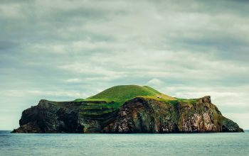 Wallpaper Green and Brown Mountain Beside Water Under Cloudy Sky