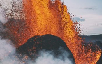Wallpaper People Standing on Rock Formation with Fire During Daytime