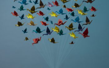 Wallpaper Person Holding Yellow, Blue, and Red Heart Balloons