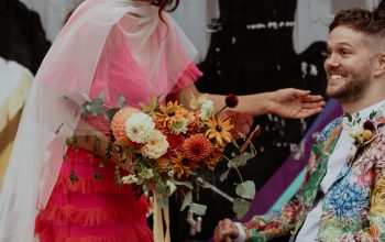 Wallpaper A Man in a Wheelchair Holding Flowers Next to a Woman