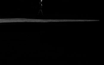 Wallpaper A Black and White Figure in the Dark