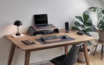 Wallpaper A Desk with a Laptop and Other Objects