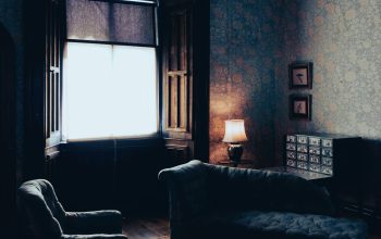 Wallpaper A Room with a Couch and a Window
