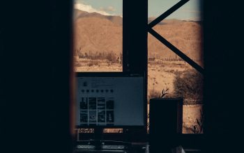 Wallpaper A Window with a Mountain and Building View