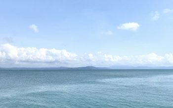 Wallpaper A Body of Water with Clouds Above