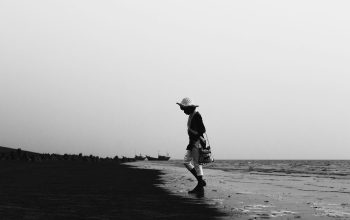Wallpaper A Black and White Beach Walker