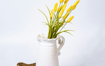 Wallpaper A White Vase with Some Yellow Flowers