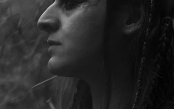 Wallpaper A Woman with Glasses and Braids