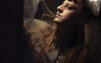 Wallpaper A Woman with Long Hair Standing in a Room