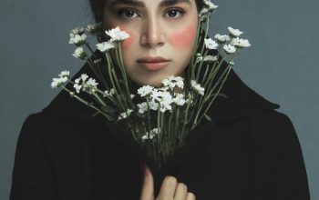 Wallpaper A Woman Hiding Behind Flowers