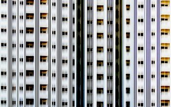 Wallpaper A Tall White Building with Lots of Windows