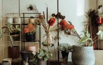 Wallpaper A Wooden Dresser Topped with Flower-Filled Vases