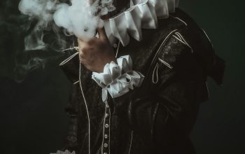 Wallpaper A Man Smoking a Cigarette in a Dark Room