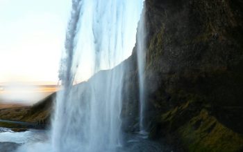 Wallpaper A Large Waterfall Spewing Water into the Air