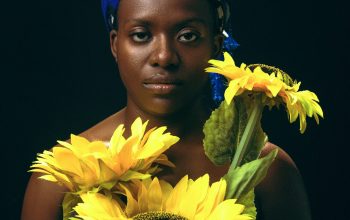 Wallpaper A Woman Holding Sunflowers