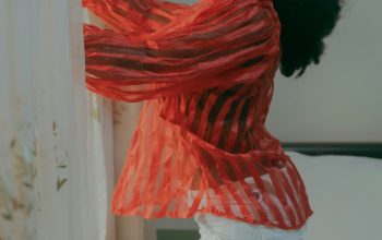 Wallpaper A Woman in White Shorts and a Red Scarf