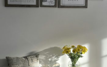 Wallpaper A Bench with a Vase of Yellow Flowers