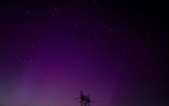 Wallpaper A Purple and Purple Sky with a Tower