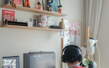 Wallpaper A Person Sitting at a Desk with a Computer