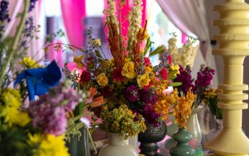 Wallpaper Bright Floral Arrangement Adorns a Decorative Table