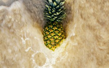 Wallpaper Yellow and Green Pineapple on Brown Sand