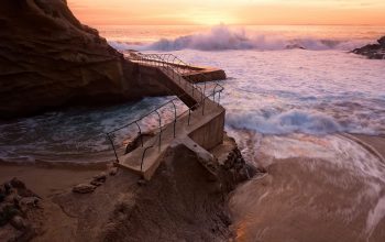 Wallpaper Waves Crashing on Rocky Coast During Sunset