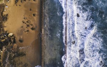 Wallpaper Aerial Photography of Sea Hitting Sand at Daytime