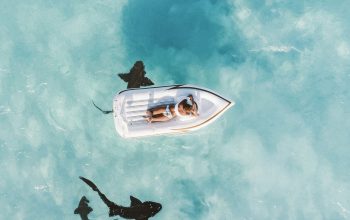 Wallpaper Person Sunbathing on White Inflatable Buoy