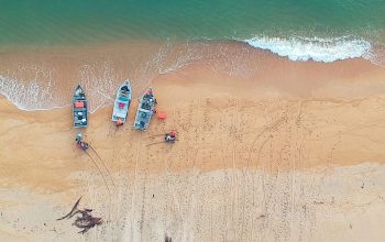 Wallpaper Aerial Photography of Boat Beside Seashore at Daytime